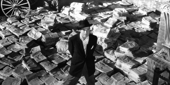 Orson Welles standing on stacks of newspapers in a scene from the film 'Citizen Kane', 1941. (Photo by RKO Radio Pictures/Getty Images)
