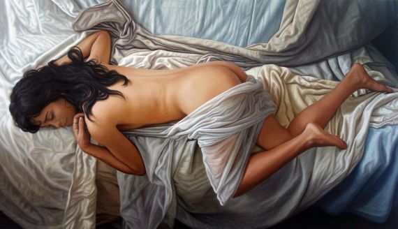 Mujer dormida entre sabanas blancas