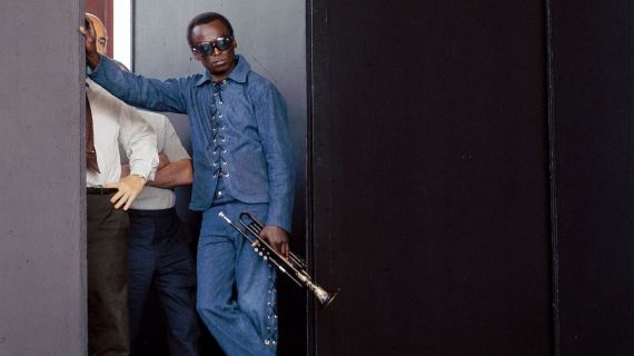 Miles Davis poses at the side of stage during the Newport Jazz Festival.