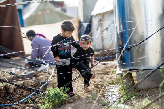 Iraq, May 2013. Two young Syrian boys are playing by their family's tent in the Domiz refugee camp in Northern Iraq. Domiz is situated near the city of Dohuk, about forty miles from the Syrian border. Approximately 40,000 Syrians are living here, in facilities provided for around half that number. April 2013 marked one year since Domiz camp opened in Dohuk, Northern Iraq. In that time it has grown to a tent city of nearly 40,000 Syrian refugees. UNICEF provides services in education, child protection, water, sanitation and hygiene, and health and nutrition. UK Nat Com local copies of these files at \Unicef-mediaphotosCOUNTRIESsyriaSY2013-refugees-IRAQ